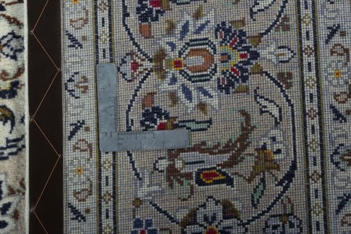 Backside of handmade 2000s Kashan rug showing knot structure and weave density