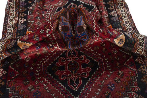 Corner detail of 2000s Shiraz rug showing border pattern and Wool pile