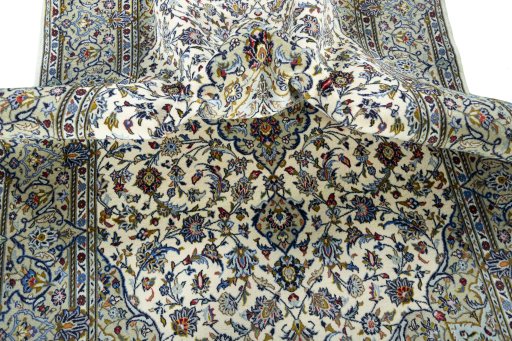 Backside of handmade 2000s Kashan rug showing knot structure and weave density