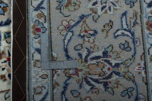 Backside of handmade 2000s Kashan rug showing knot structure and weave density