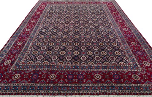 Surface texture of 2000s Mashad rug with natural Wool and intricate pattern