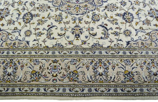Corner detail of 2000s Kashan rug showing border pattern and Wool pile