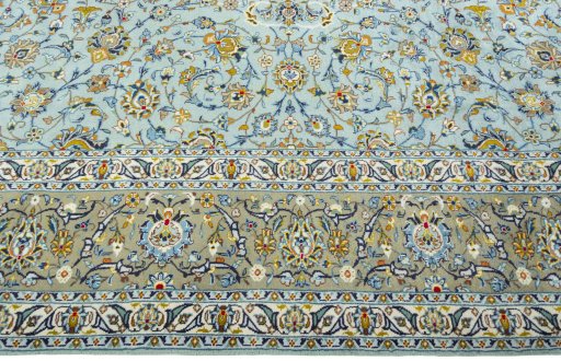 Corner detail of 2000s Kashan rug showing border pattern and Wool pile