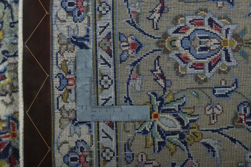 Backside of handmade New Kashan rug showing knot structure and weave density