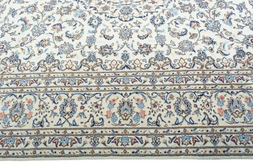 Corner detail of 2000s Kashan rug showing border pattern and Wool pile