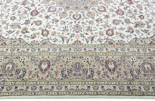 Corner detail of 2000s Kashan rug showing border pattern and Wool pile