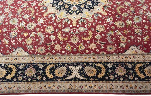 Corner detail of 2000s Tabriz 50/60/70 Raj rug showing border pattern and Cork pile