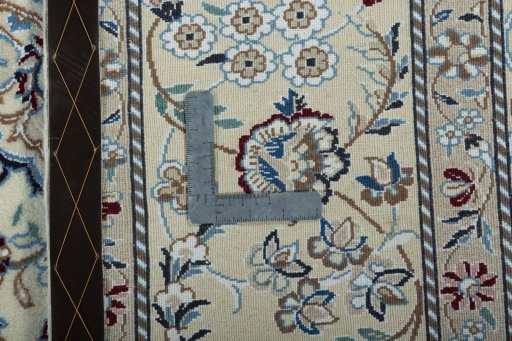 Backside of handmade 2000s Nain rug showing knot structure and weave density