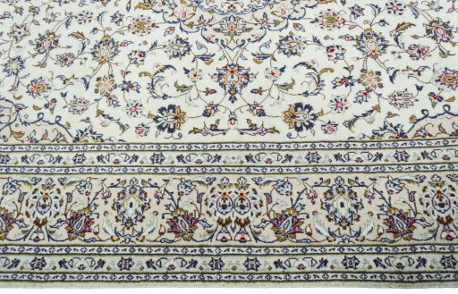 Corner detail of 2000s Kashan rug showing border pattern and Wool pile
