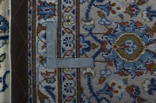 Backside of handmade 2000s Kashan rug showing knot structure and weave density