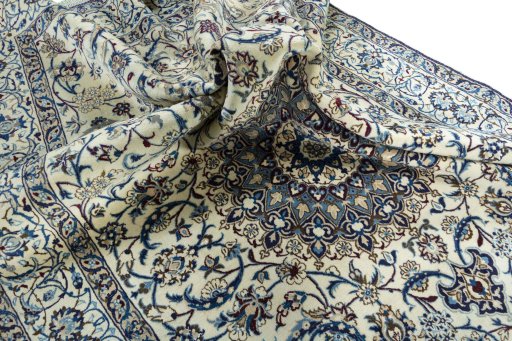 Surface texture of 2000s Nain rug with natural Wool and intricate pattern