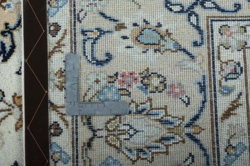 Backside of handmade New Kashan rug showing knot structure and weave density