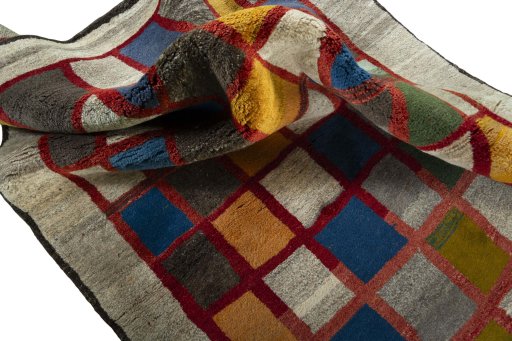 Corner detail of 2000s Persian Gabbeh rug showing border pattern and Wool pile