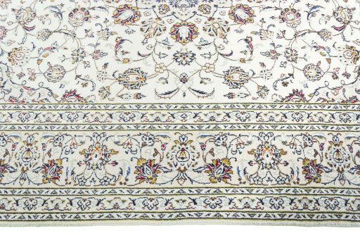 Corner detail of 2000s Kashan rug showing border pattern and Wool pile