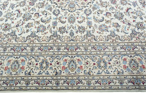 Corner detail of 2000s Kashan rug showing border pattern and Wool pile
