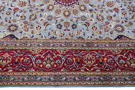 Corner detail of 2000s Kashan rug showing border pattern and Wool pile