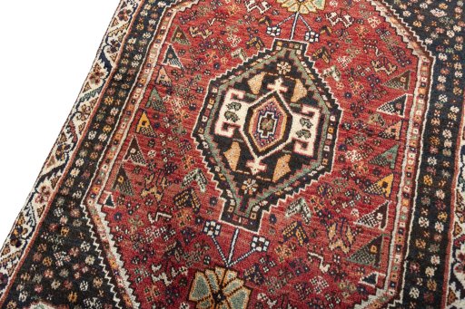 Backside of handmade 2000s Shiraz rug showing knot structure and weave density
