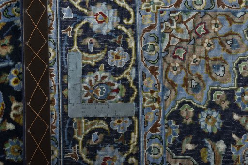 Backside of handmade 2000s Kashan rug showing knot structure and weave density