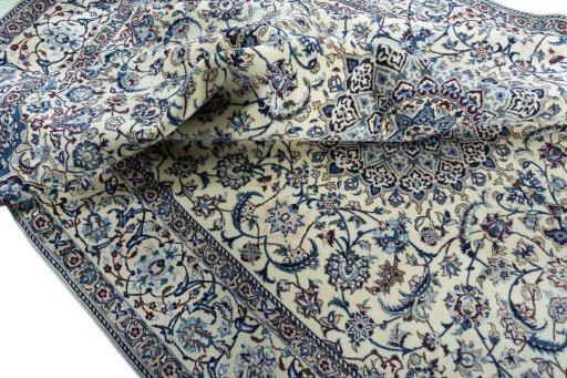 Surface texture of 2000s Nain rug with natural Wool and intricate pattern