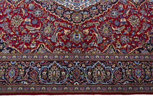 Corner detail of 2000s Kashan rug showing border pattern and Cork pile