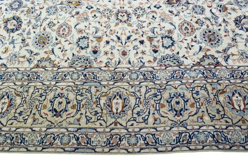 Corner detail of 2000s Kashan rug showing border pattern and Wool pile