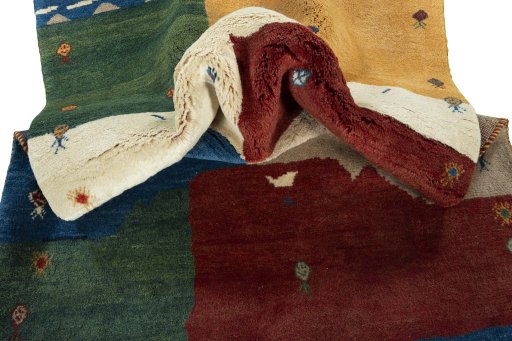 Corner detail of 2000s Persian Gabbeh rug showing border pattern and Wool pile