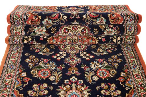 Full view of 1990s Ghom rug from Iran / Persia, 326 × 85 cm in Dark blue tones
