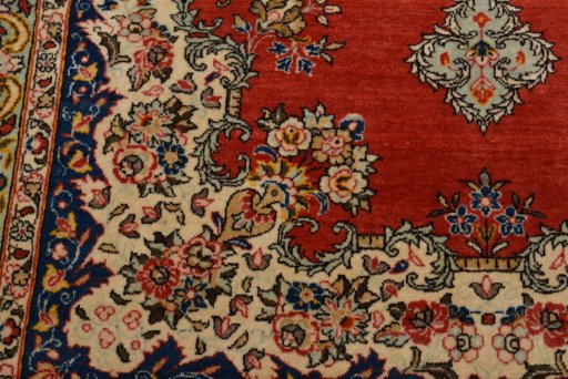 Backside of handmade 1950s Ghom rug showing knot structure and weave density