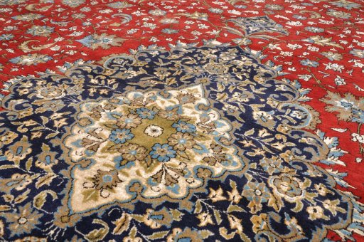 Surface texture of 1970s Ghom rug with natural Wool and intricate pattern