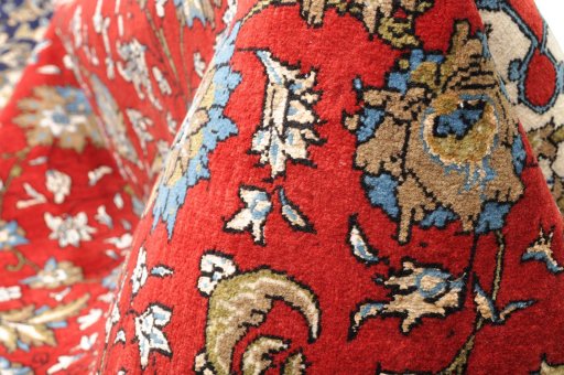 Corner detail of 1970s Ghom rug showing border pattern and Wool pile