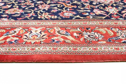 Corner detail of 2000s Ghom rug showing border pattern and Cork pile