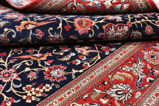 Surface texture of 2000s Ghom rug with natural Cork and intricate pattern