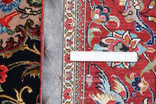 Backside of handmade 2000s Ghom rug showing knot structure and weave density