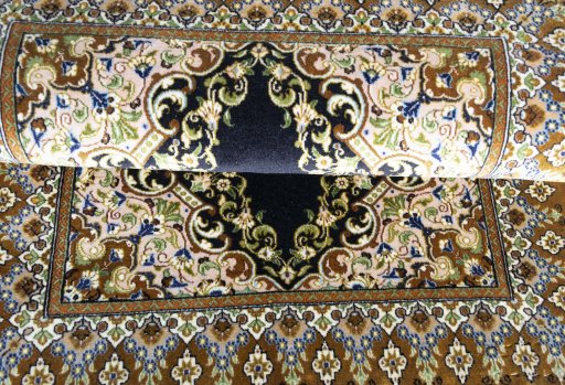 Corner detail of 2000s Ghom rug showing border pattern and Cork pile