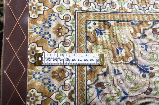 Surface texture of 2000s Ghom rug with natural Cork and intricate pattern