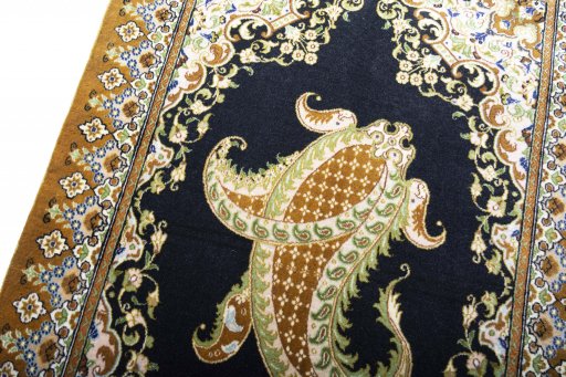Backside of handmade 2000s Ghom rug showing knot structure and weave density