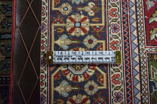Corner detail of 2000s Ghom rug showing border pattern and Wool pile