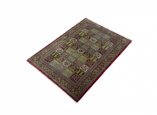 Corner detail of 2000s Ghom rug showing border pattern and Wool pile