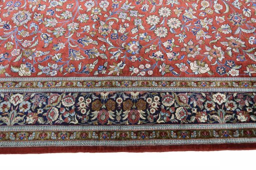 Corner detail of 1970s Ghom rug showing border pattern and Silk pile