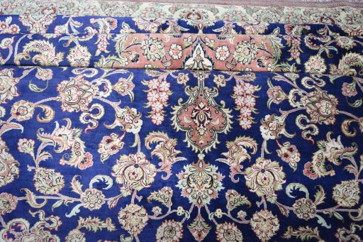 Surface texture of 2000s Ghom rug with natural Silk and intricate pattern