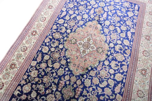 Backside of handmade 2000s Ghom rug showing knot structure and weave density