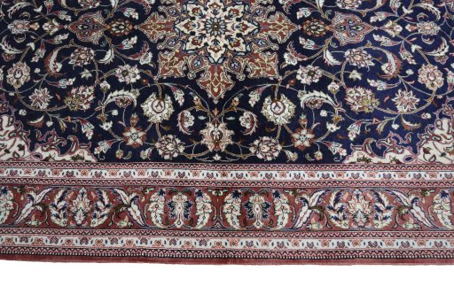 Corner detail of 2000s Ghom rug showing border pattern and Silk pile