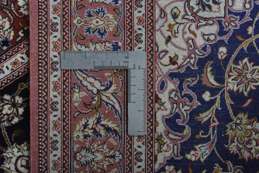 Backside of handmade 2000s Ghom rug showing knot structure and weave density