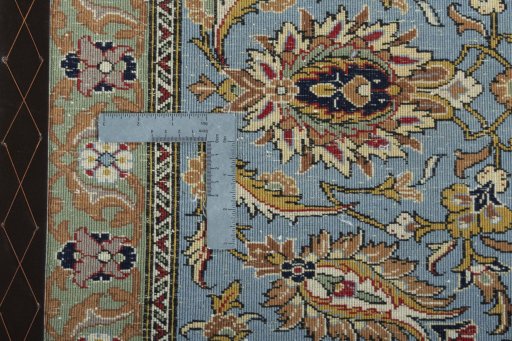 Backside of handmade 1950s Ghom rug showing knot structure and weave density
