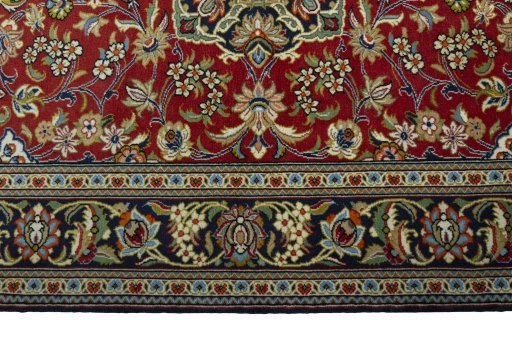 Corner detail of 2000s Ghom rug showing border pattern and Cork pile