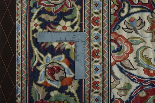 Backside of handmade 2000s Ghom rug showing knot structure and weave density