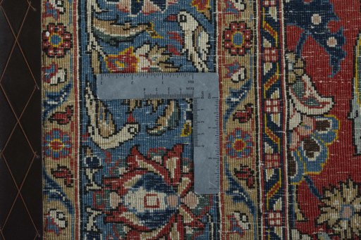 Backside of handmade 1970s Ghom rug showing knot structure and weave density