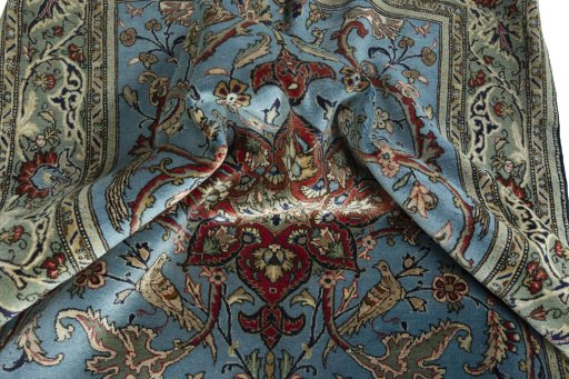Surface texture of 1970s Ghom rug with natural Wool and intricate pattern