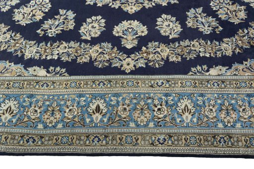 Corner detail of 2000s Ghom rug showing border pattern and Wool pile