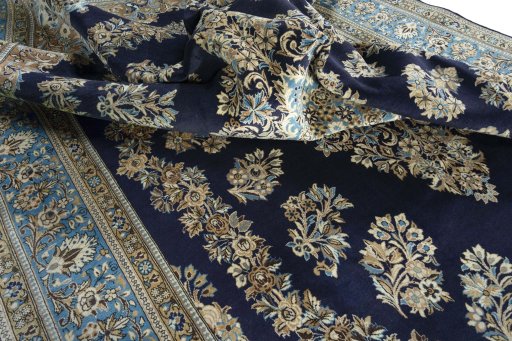 Surface texture of 2000s Ghom rug with natural Wool and intricate pattern